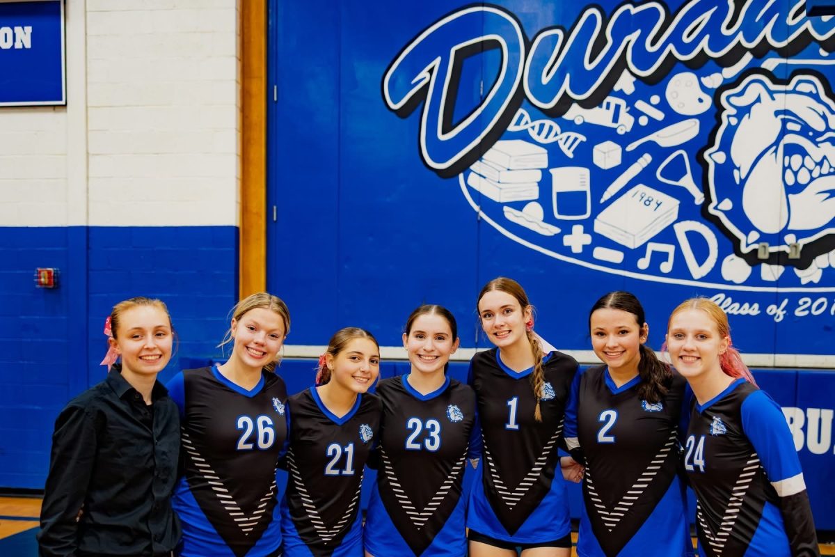 After winning undefeated in conference, the senior girls pose for a photo together one last time.